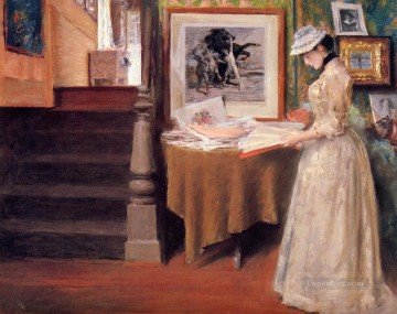 three women at the table by the lamp Painting - Interior Young Woman at a Table William Merritt Chase